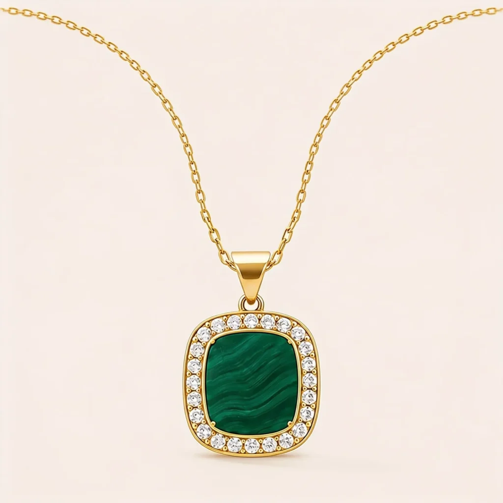 Gold chain necklace with square malachite pendant surrounded by cubic zirconia stones.